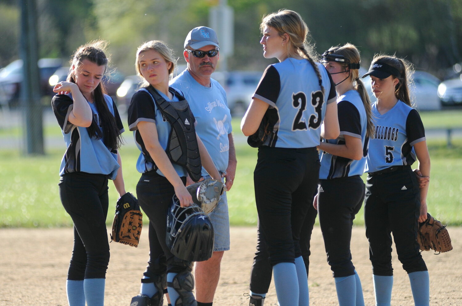 Meeting on the mound. Pictured are Hannah Abplanalp, left; Nicole Reeves; Coach Anthony Durkin; Elaine Herbert; Liz Reeves; and Sam Heller...